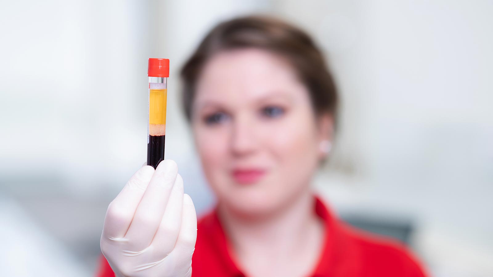 employee looking a sample vial