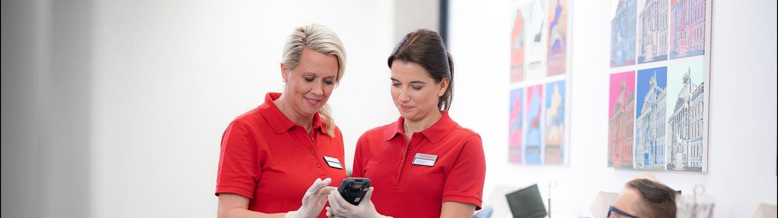 two employees checking on a donor